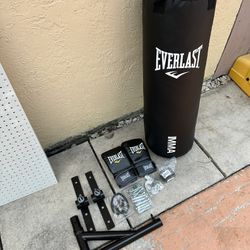 NEW Everlast  70 Pound Hangable Heavy Punching Bag with Boxing Gloves, Hand Wraps, Bungee Cord, and Assembly Chain, Black/ WALL STAND