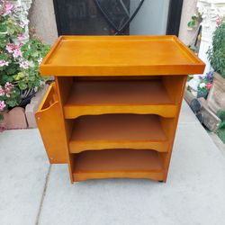 VINTAGE MAGAZINE TABLE WITH WHEELS.