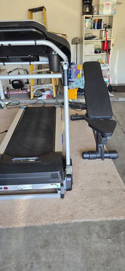 Xterra Fitness TRX2500 folding treadmill and adjustable weight bench.