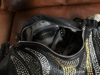 Black purse, shoulder or arm, covered in gold, silver, and black rhinestones.