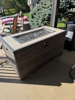 Large Rectangular 4x2x2’ Wicker Propane Fire Pit Table with Tile Top! Propane insert wheels in & out. Comes with NEW cover.  Durable outdoor fire pit 