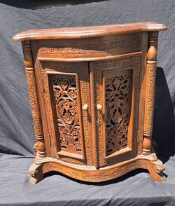 Intricately  carved rosewood accent cabinet