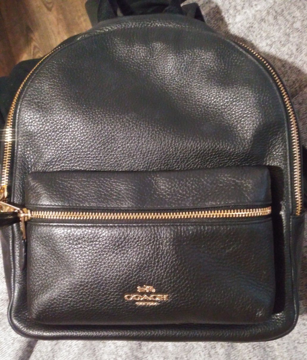 Authentic Charlie black leather Coach backpack. Black/Gold. Good condition.
