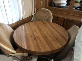 Kitchen table with three chairs and a leaf