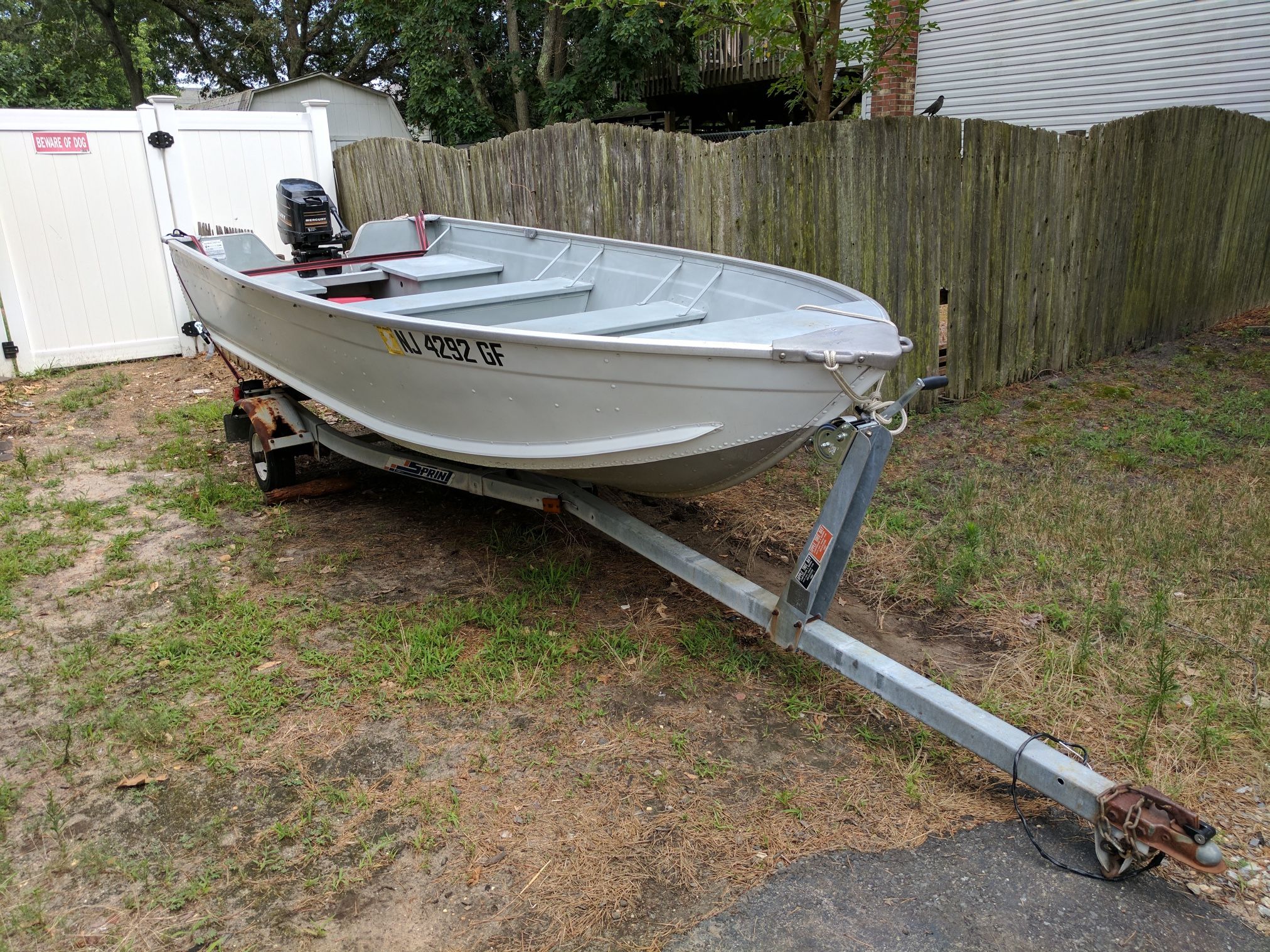 14' Aluminum Grumman with trailer and 18 hp Mercury 18XD Motor