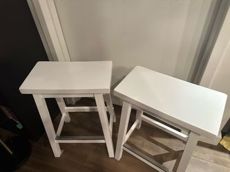 Matching pair of white-painted wooden counter/bar stools, with a simple farmhouse/cottage design.