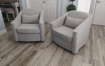 Two gray swivel barrel Accent Chairs