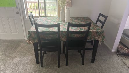 Good condition dinning table with four chairs