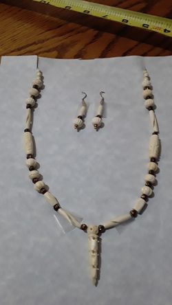 Bone necklace with carved charm