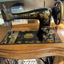 Antique Sewing Machine In Oak Cabinet