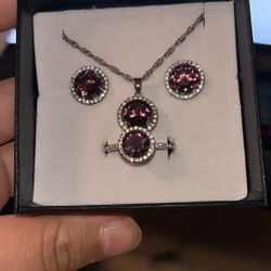 Stimulated MS fist, stimulated diamond ring size 10. Earrings, pendant necklace 18 inches in Silvertone 9.00CTW.