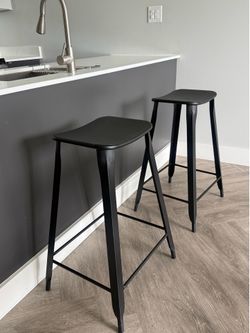 2 black metal barstools