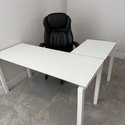 White glass top 2-piece desk with executive chair and pad.