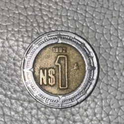 Highly sought-after and extremely rare collector's item: a 1882 N$1 Estados Unidos Mexicanos coin featuring a unique date error. This ex