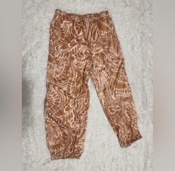 Chic pants with a unique pattern. Features cream and orange hues. New s tan pants boho casual stretchy hippie rave raver festival joggers