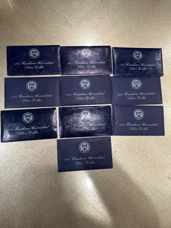 10x 1971 US Mint Eisenhower uncirculated silver dollar set in its original blue Treasury envelope.