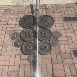 135lbs weight plates + olympic barbell