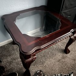 Solid wood coffee table with a glass top and cherry 