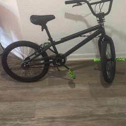 It’s Mid Size . It’s All Black With Neon Green Pedals And Neon Green Bike Pegs.  