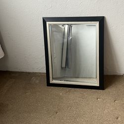 black and silver framed wall mirror