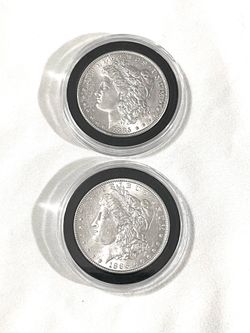About uncirculated sealed in capsules 1885 and 1886 Morgan, silver dollars. Valued $98 each