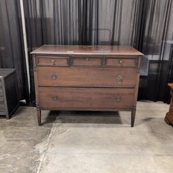 Dark Wood Three-Drawer Dresser with Recessed Panels