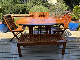 David Smith Co.  Teak patio table with 4 chairs and a bench.