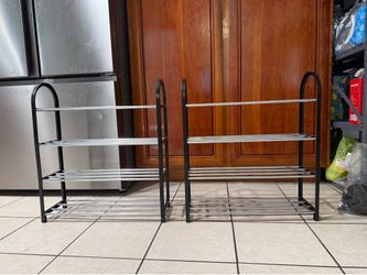 Two small, brand-new four-tier shoe racks.