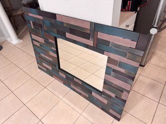 metal multi block mirror. 59”X39”. The mirror is 27 1/2”X19”. Used in good condition.