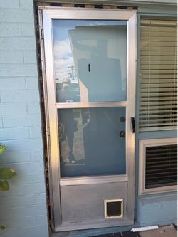 Used screen door with doggie door.