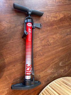 a Bell Air Attack 350 High-Volume Bicycle Pump, recognizable by its red barrel and black handle.