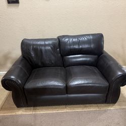 Comfortable brown leather sofa. No tears, a bit of paint or something that should come out fairly easily