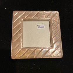 Silver plated picture frame 4 / 4 inches ,needs polishing.some wear on it do to just moving it around.