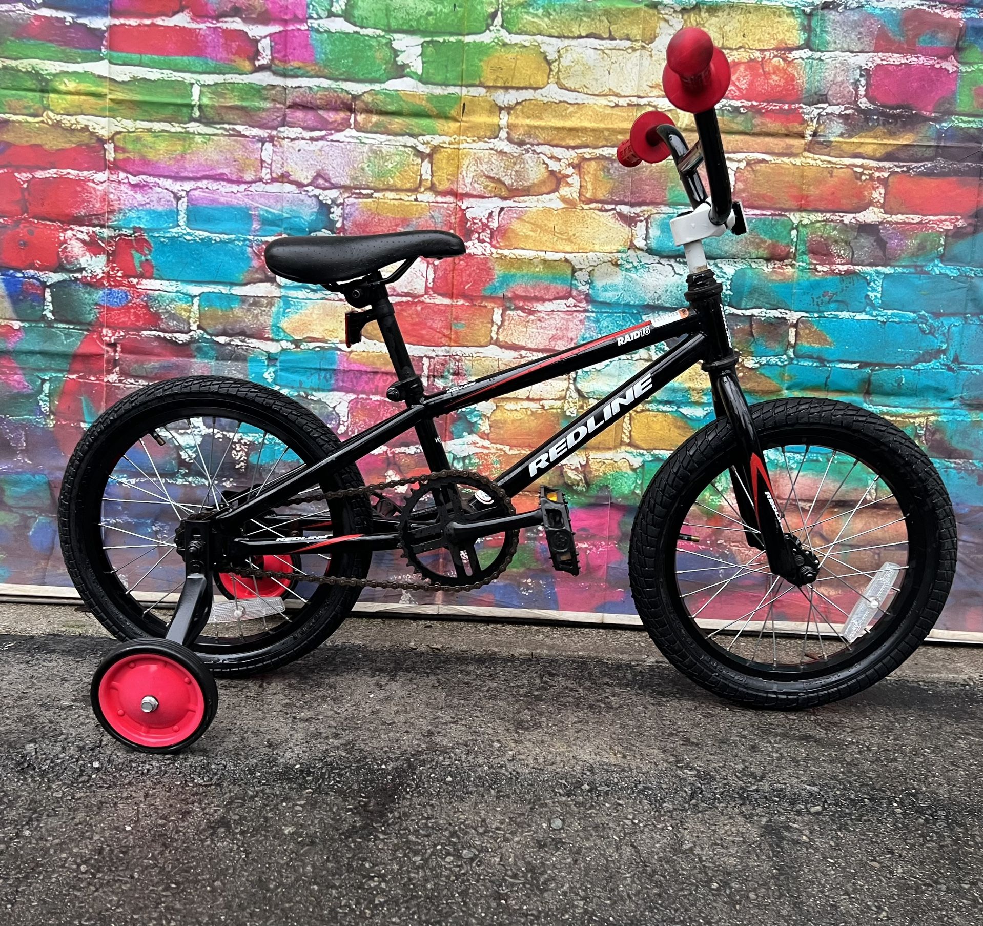 REDLINE BMX BIKE 16″ alloy rims, training wheels, coaster brake equipped perfectly for beginner learning to ride or race. Excellent like new.  $85