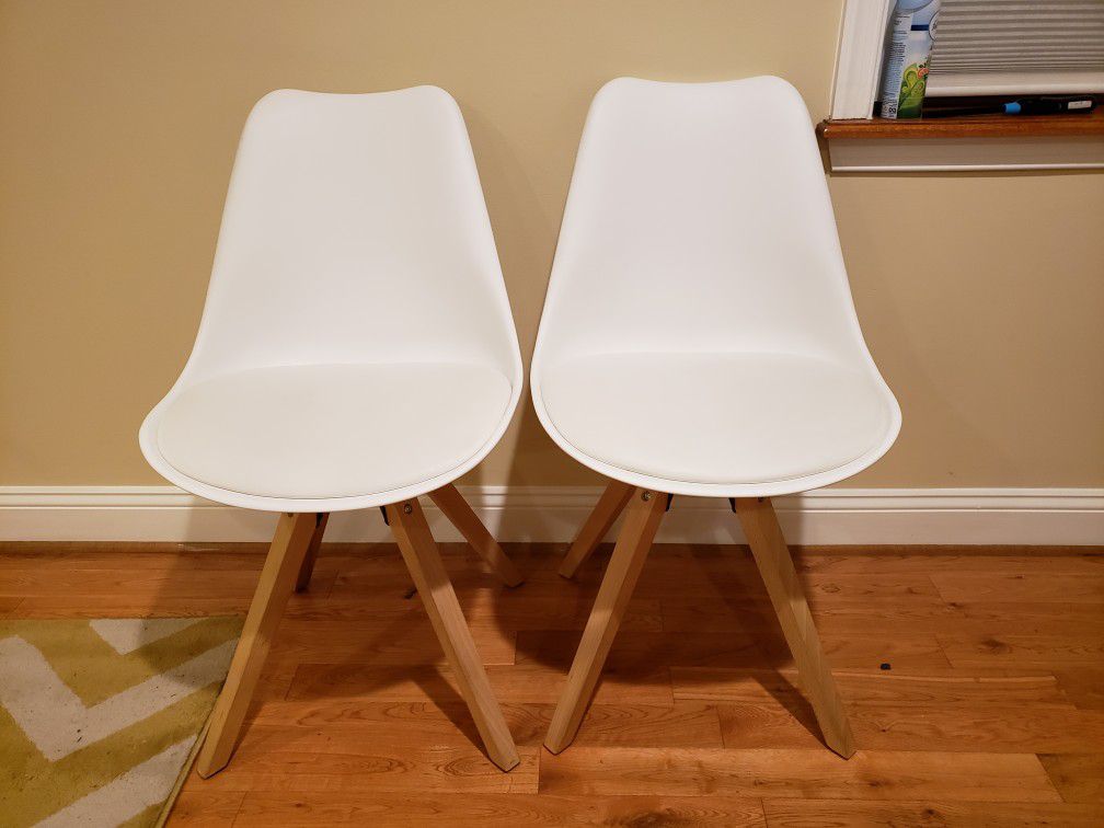 Two white dining chairs