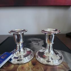 Pair of International Silver Company silver-plated candlesticks with a ridged edge design.