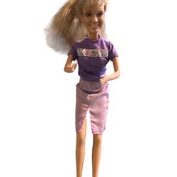 2003 Barbie  in cute purple dress  bendable legs no original box and has wear she is over 20 years old.   T-10