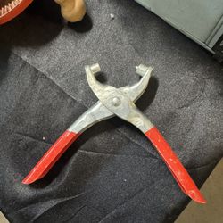 handheld grommet eyelet pliers used for installing metal eyelets into various materials. 