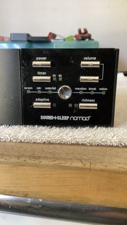 The device shown is the SOUND+SLEEP nomad™ sound machine, made by Adaptive Sound Technologies.