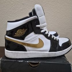 Nike Air Jordan 1 Mid SE Patent Black Gold sneakers.
