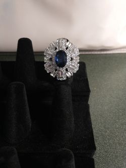 Dark Stone In The Middle Or The Ring And White Stones All The Around The Ring