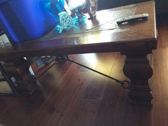 Coffee table in great shape. Solid wood. Slate top with wrought iron detail..