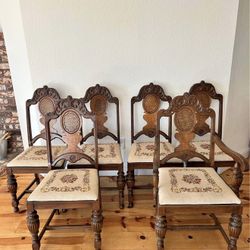 5 beautiful antique Jacobean dining chairs with hand embroidered seats. Set come with 4 regular chairs, 1 arm chair for host. There are some stains on