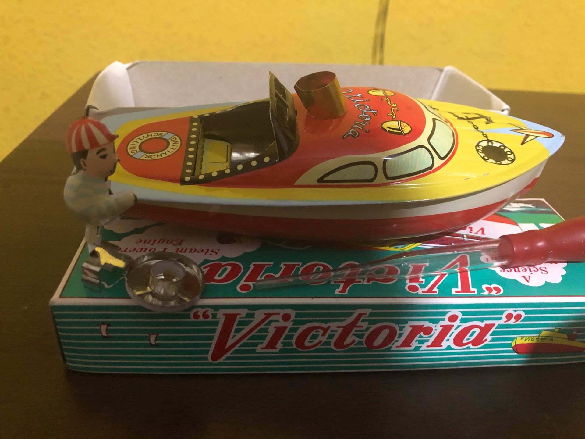 Victoria tin toy boat has a real boiler to power its engine! This traditional English toy is colorful classic floating "pop pop" toy $10