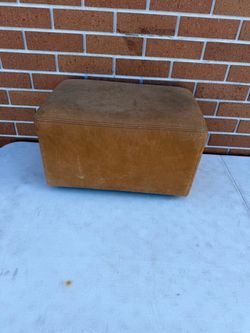 A. Rudin Upholstered Foot Stool Ottoman. Used in good with some cosmetic blemishes. These blemishes are in the form of some scratches and scuff mark