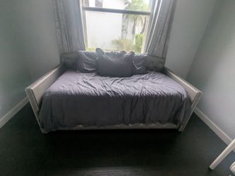 Twin daybed with mattress pads and cushions