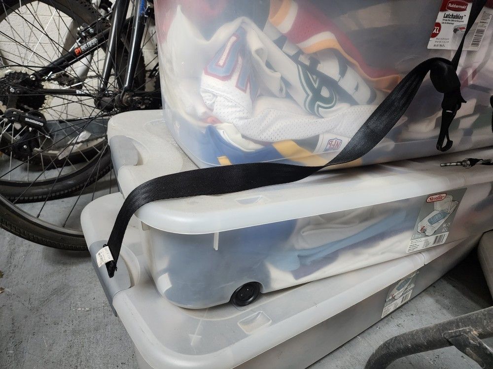 Bins Full Of Football And Baseball Jerceys 