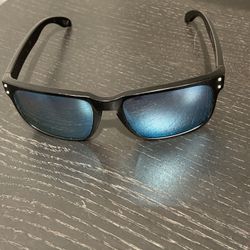 Oakley Holbrook Sunglasses (OO9102-E855) - Matte Black Frame with Mirrored Blue-Tinted Lenses These are authentic Oakley Holbrook sunglasses, model OO