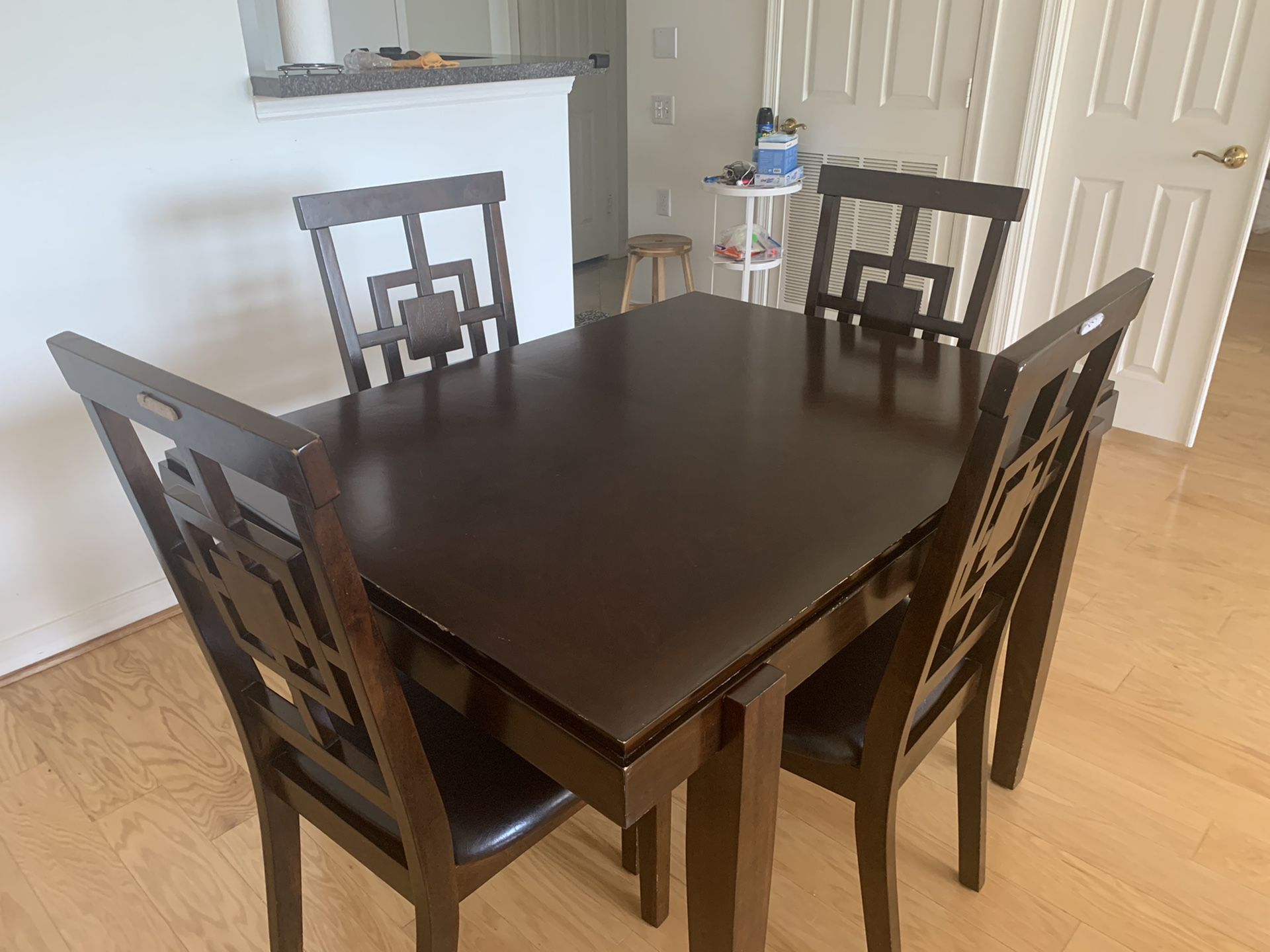 Dining table with four padded chairs