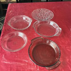Four Pyrex pie plates and 10.25” service embossed glass plate $5 each 